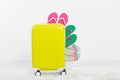 Yellow suitcase on white background Summer holidays. summer flip flops or slippers.Sandals beach.Travel valise or bag. Mo Royalty Free Stock Photo