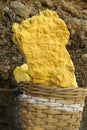 yellow sulfur inside woven bamboo basket at volcanic crater Kawah Ijen Royalty Free Stock Photo