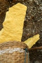 yellow sulfur inside woven bamboo basket at volcanic crater Kawah Ijen