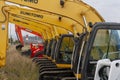 The yellow Sumitomo excavators are lined up in a single line.