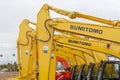 The yellow Sumitomo excavators are lined up in a single line.