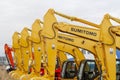 The yellow Sumitomo excavators are lined up in a single line.