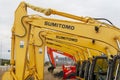 The yellow Sumitomo excavators are lined up in a single line.