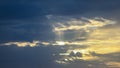 Yellow Sun rays from grey clouds Royalty Free Stock Photo