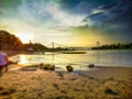 Yellow Sundown over the sandy Beach of the river Rhein in Cologne with cloudy sky, Chappell and bridge landscape Royalty Free Stock Photo