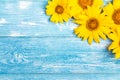 Yellow sunflowers on blue wooden background. Copy space.