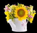 Yellow sunflowers and colored wild flowers in a white sprinkler, close up Royalty Free Stock Photo