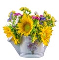 Yellow sunflowers and colored wild flowers in a white sprinkler, close up