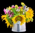 Yellow sunflowers and colored wild flowers in a white sprinkler, close up Royalty Free Stock Photo