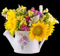 Yellow sunflowers and colored wild flowers in a white sprinkler, close up Royalty Free Stock Photo