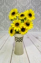 Yellow sunflowers, coloredartificial flowers in a decorative vase Royalty Free Stock Photo