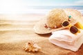 Yellow sunglasses, sunhat and towel on a beach Royalty Free Stock Photo