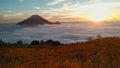 yellow sunrise on mountain with white cloud and blue sky and fantastic green forest nature Royalty Free Stock Photo