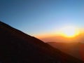 yellow sunrise on mountain with white cloud and blue sky and fantastic green forest nature Royalty Free Stock Photo