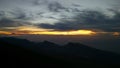 yellow sunrise on mountain with white cloud and blue sky and fantastic green forest nature Royalty Free Stock Photo