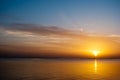 Yellow sunrise on the ocean. Sun under the red sea in the morning. Sunset and reflex on water in the evening. Golden Sunrise Royalty Free Stock Photo