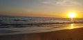 Yellow sunset at the Carpinteria sunset sand across the water.