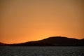 Yellow sunset with the silhouette of the Mallorcan coast in Mallorca, Balearic Islands, Spain Royalty Free Stock Photo