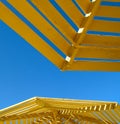 Yellow sunshade and blue sky Royalty Free Stock Photo