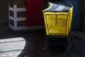 Yellow supermarket trolleys in the sunlight.