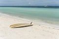 A yellow surfboard near the shoreline. At Dumaluan Beach, Panglao Island, Bohol, Philippines