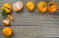 Yellow sweet isolated peeled and whole mandarin clementine tangerine on wooden rustic vintage table with leaf. Tangerines backgrou Royalty Free Stock Photo