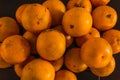 Yellow sweet oranges, stacked on a black table. Accommodated for sale Royalty Free Stock Photo
