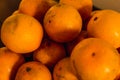 Yellow sweet oranges, stacked on a black table. Accommodated for sale. 2