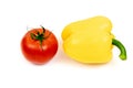 Yellow sweet pepper with tomato in a black plate isolated on white background. Royalty Free Stock Photo