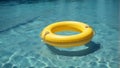 yellow swimming pool ring float in blue water Royalty Free Stock Photo