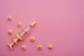 Yellow syringe for applying glaze on confectionery products on pink