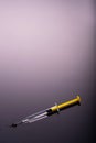 Yellow Syringe on black background