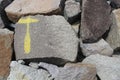 Yellow T letter symbol on a dam rock