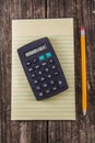 Yellow Tablet Pencil & Calculator on Vintage Desk Royalty Free Stock Photo