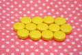 Yellow tablets pills on pink background Royalty Free Stock Photo