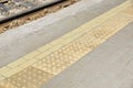 yellow tactile path for people with disabilities on the railway