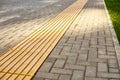 Yellow tactile paving on walkway, tactile ground surface indicators for blind and visually impaired Royalty Free Stock Photo