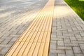 Yellow tactile paving on walkway, tactile ground surface indicators for blind and visually impaired Royalty Free Stock Photo