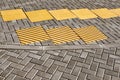 Yellow tactile paving on walkway, tactile ground surface indicators for blind and visually impaired Royalty Free Stock Photo