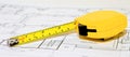 Yellow Tape Measure on Construction Drawing