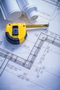 Yellow tapeline and blueprints Royalty Free Stock Photo