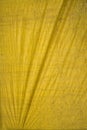 Yellow tarpaulin with folds