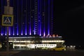 Yellow taxi car in front of Izmailovo Alfa Hotel building in Moscow, Russia.