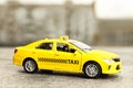 Yellow taxi car model on city street Royalty Free Stock Photo