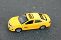 Yellow taxi car model on city street Royalty Free Stock Photo