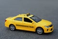 Yellow taxi car model on city street Royalty Free Stock Photo