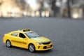 Yellow taxi car model on city street Royalty Free Stock Photo