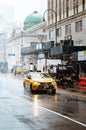 Yellow Taxi driving through heavy snowstorm