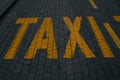 Yellow taxi sign on the cobblestones in the center of the old town. Belgrade, Serbia. Letter designation, lane on the