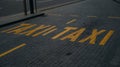 Yellow taxi sign on the cobblestones in the center of the old town. Belgrade, Serbia. Letter designation, lane on the Royalty Free Stock Photo